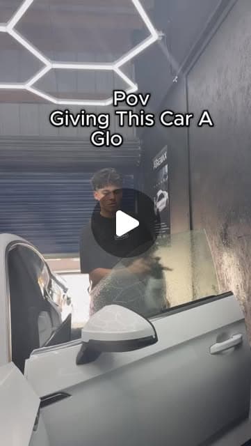 Installer prepping a car window before applying tint film