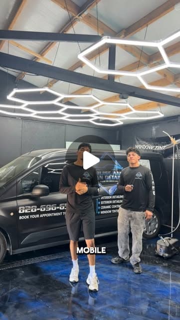 Zair and Darian in their tint studio with the branded van